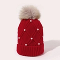 Detailed knit of red winter beanie featuring white pearls and a large fluffy faux fur pompom - Red