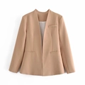 Detailed close-up of a camel-colored collarless blazer with pocket stitching and clean lines - XS / Khaki