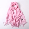Pink cashmere scarf with tassels and official brand tag on a clean white background - Pink