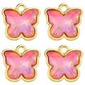 Detailed macro view of four butterfly charms with gold edges and pink crystal filling - Aurora Pink