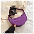Detailed top view of a purple nylon crescent bag on a light blazer and white fabric - Purple