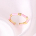 Macro shot of pink enamel bamboo ring with gold plating and sparkling zircon details - Adjustable Open / Pink