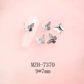 Macro shot of 9x7mm silver 3D butterfly nail charms with realistic wing texture - Silver Hollow Butterfly (MZH-7370) / 9*7mm
