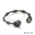 Brazalete de calavera vintage punk de acero inoxidable con diseño de hueso detallado - Plata antigua