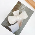 Elegant pearl white acetate bow claw clip with iridescent finish on fashion magazine - Small / Mermaid White