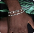 Close-up of stacked silver stainless steel Figaro and rope chains on wrist - Style 7