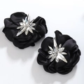 Close-up of black satin camellia flower earrings with a sparkling rhinestone center - Style 5 (Black/Ornate)
