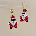 Detail of handmade beaded Santa Claus earrings with golden snowflake stud and red crystals - Snowflake Santa Claus-Triangle Clip / Clip-On Earrings
