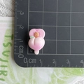 Close-up of a small peach resin charm showing 1.5 cm size measurement on a cutting mat - Pink Peach Popsicle