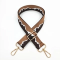 Detail of adjustable brown nylon bag strap with white zigzag pattern and gold metal hardware - Brown Coffee