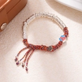 Detail of hand-woven bracelet with silver rings, safety charm and colorful tassels - L312-3 Fortune (Enamel)