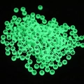 Macro shot of green luminous round beads with letter W for DIY jewelry making - Letter W / Luminous Green