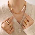 Gold chain and pearl necklace with checkered and snake style rings on model - Gold