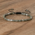 Adjustable woven bracelet with grey imperial stones and silver spacers on wood - No.27 Grey Labradorite