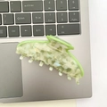 Detail of light green marble acetate hair claw clip on a laptop keyboard surface - Light Green