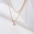 Detailed view of single white pearl pendant on a delicate gold layered chain necklace - Double Layer Chain Single Pearl