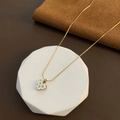 Detail of a gold snake chain with a heart pendant on a white geometric display - 01-H13 Titanium Steel Heart Necklace Gold