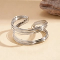 Detail view of silver twisted geometric bangle with polished metallic multi-layer coil design - Silver