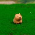 Cute brown resin capybara figurine miniature placed on green moss for desk decor - No. 4 Sitting
