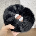Macro shot of fluffy black plush scrunchie with sparkling silver thread details - Black