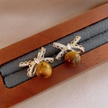 Detail of golden bow earrings with zircon and amber-colored stone in velvet box - 42# Bowknot Tiger Eye Bead Pendant Studs (925 Sterling Silver Earring Post)