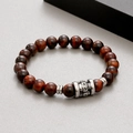 Detail of red tiger eye beads and metal skull charm on the elastic beaded bracelet - Red Tiger Eye Style (KB183250-TLX)