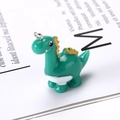 Handmade green resin dinosaur charm with orange spikes and metal hanging ring - Small Dinosaur