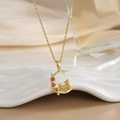 Detail of gold moon pendant featuring tiny cats, a red rose, and shimmering pavé zircons - Cats and Red Rose Moon (XL0317)
