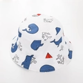 Close-up of white cotton baby sun hat featuring nautical whale and sailboat patterns - White Whale
