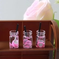 Macro shot of miniature pitaya beverage bottles with realistic fruit slices and straws - Fruit Cup 2