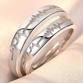 Detailed macro view of silver couple rings with electrocardiogram pattern on silk fabric - Heartbeat