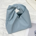 Light blue lychee grain leather handbag featuring a unique minimalist knotted handle design - Blue