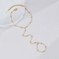 Golden stainless steel slave bracelet with small beads shown on a textured surface - Gold - Simple Beaded Slave Bracelet
