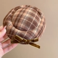 Close-up of brown plaid fabric beret with green velvet bow detailing for autumn wear - Coffee Grid Duckbill Clip