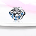 Macro shot of silver shell charm with blue stones and starfish detail for jewelry - Ocean Stone Inlaid Shell Bead (W-PAC444)
