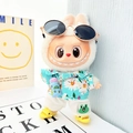 Plush doll in daisy print blue shirt, white pants and miniature yellow clogs footwear - Blue Water Bottle + Yellow Shark Shoes + Sky Blue Beach Outfit / First And Second Generation Keychains Are Compatible With La Cloth Dolls. Dolls Not Included.