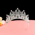 Macro view of luxury baroque crown with emerald green gems and white rhinestones - No.7 Silver (Green Stone)