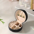 Compact black round portable jewelry box organizer with velvet interior for rings - Elegant Black