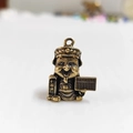 Macro shot of brass God of Wealth pendant with abacus and fortune scroll details - Abacus Style