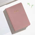 Pink faux leather A6 pocket notebook with gold-stamped 'NOTES' on a desk setup - Purple / Line