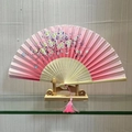 Traditional folding fan with pink cherry blossom pattern and delicate silk tassel - Silent Blossoms (Pink)