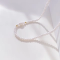 Detail of irregular baroque pearl necklace with golden accent beads on a white surface - Single Baroque Pearl Splicing