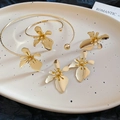 Macro view of gold flower jewelry set with necklace, bracelet and ring on tray - Gold (4-Piece Set)