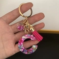 Detail of resin letter C keychain with pink tassel and liquid glitter sphere charm - Small Ball Tassel Clasp / Letter C