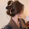 Large wavy hair claw clip in tortoiseshell resin shown on model's hair from the back - Splicing Snake Wave Claw Clip