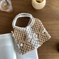 Detailed close-up of bohemian geometric hand-woven cotton rope bag on a wooden surface - Khaki