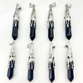 Detail of eight obsidian hexagonal point pendants with ornate silver filigree metal caps - Obsidian