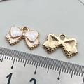 Pink enamel bow tie pendant with gold alloy finish and measurement scale view - White with Bowknot