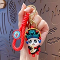 Cute panda keychain featuring Sichuan opera costume and red woven strap - Face Changing Panda