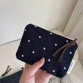 Handheld view of navy denim canvas coin purse with white polka dots and zipper - Polka Dot